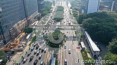 Aerial view of hectic traffic on the road with office buildings in the Jakarta city, Indonesia Stock Photo