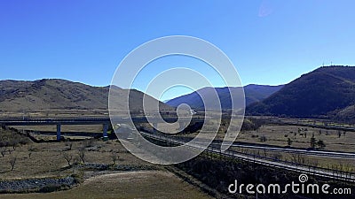 Aerial view of a highway intersection in the mountains of central Italy. Rieti 2020. Drone that rises on a highway intersection in the mountains of central Italy stock footage Aerial view of a highway intersection in the mountains of central Italy. Rieti 2020. Drone that rises on a highway intersection in the mountains of central Italy stock footage