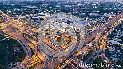 Aerial view highway road intersection at dusk for transportation, distribution or traffic background Stock Photo