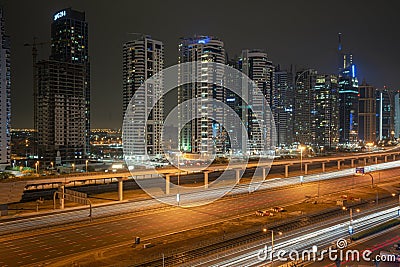 Aerial view of illuminated JLT skyscrapers. Towers along Sheikh Zayed Road. Stock Photo