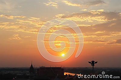 Aerial view image of morning sky in Thailand with silhouette image of Thai style ornament building and beautiful sunrise tropical Stock Photo