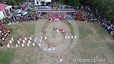 Aerial view of Indonesian flag lowering ceremony witnessed by villagers. Indonesia Independence Day Editorial Stock Photo