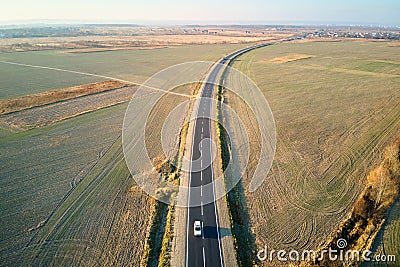 Aerial view of intercity road with blurred fast driving car at sunset. Top view from drone of highway traffic in evening Editorial Stock Photo