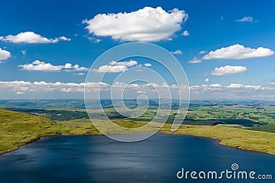 Aerial view of a lake formed at the base of green mountains Llyn y Fan Fach, Brecon Beacons, Wales Stock Photo