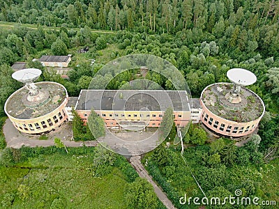 Aerial view is a large space antenna against a green forest. Stock Photo