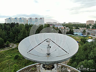 Aerial view is a large space antenna against a green forest. Space communications Stock Photo