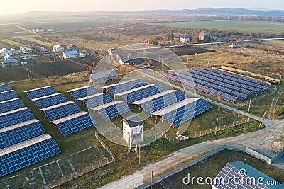 Aerial view of large sustainable electrical power plant with rows of solar photovoltaic panels for producing clean Editorial Stock Photo