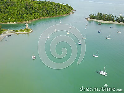 Aerial view of a Lighthouse, boat and yatches docked in marina Stock Photo