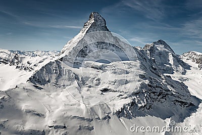 Aerial view of majestic Matterhorn mountain in front of a blue sky Stock Photo