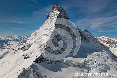 Aerial view of majestic Matterhorn mountain in front of a blue sky Stock Photo
