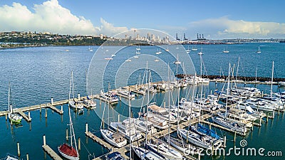 Aerial view on a marina and resting boats with Auckland city center on the background. New Zealand. Editorial Stock Photo