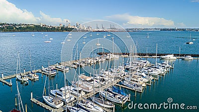 Aerial view on a marina and resting boats with Auckland city center on the background. New Zealand. Editorial Stock Photo