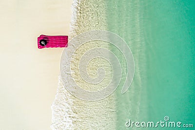 Aerial view at mattress in the transparent turquoise sea. Summer seascape, beautiful waves, colorful water. Top view from drone Stock Photo