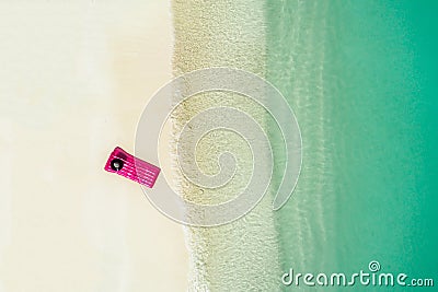 Aerial view at mattress in the transparent turquoise sea. Summer seascape, beautiful waves, colorful water. Top view from drone Stock Photo