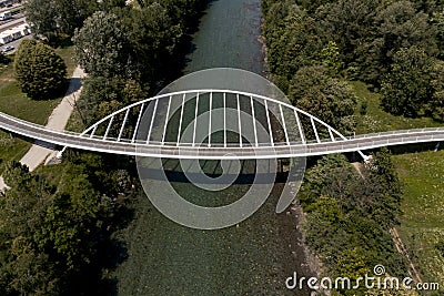 Aerial view of a modern arch shaped design pedestrian bridge over the Ticino river in Switzerland Editorial Stock Photo