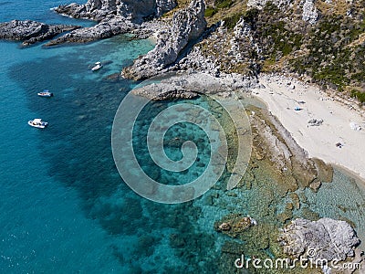 Aerial view of moored boats floating on a transparent sea. Scuba diving and summer holidays. Capo Vaticano, Calabria, Italy Stock Photo
