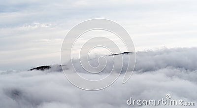 Aerial view of mountains engulfed in clouds Stock Photo