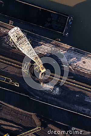 Aerial view of moving crane with a heap of coal next to the coal Stock Photo