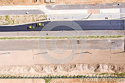 Aerial view on the new asphalt road under construction. road rollers leveling new asphalt Stock Photo