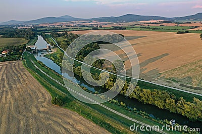Aerial view of Nitra river flowing in lowlands of western Slovakia, with small hydroelectric plant build on it Stock Photo