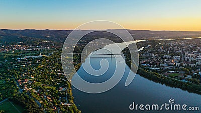 Aerial view of Novi Sad cityscape with river and Liberty bridge at sunset Stock Photo