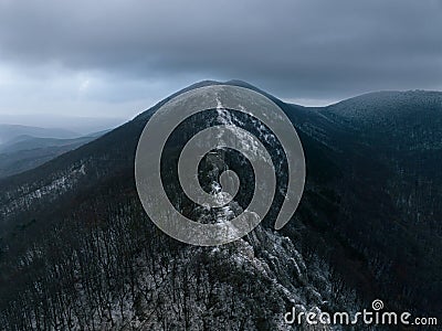 Aerial view of old ruins of fortress in the middle of winter forest. Drone view of snowy landscape with broken stone Stock Photo