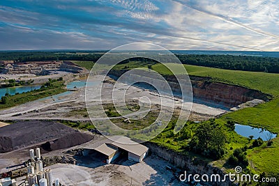 Aerial view of open cast mining panorama quarry with lots of machinery at work equipment at a plant Stock Photo