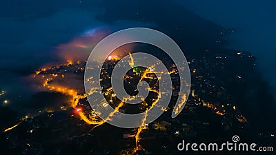 Aerial view of panorama landscape at the hill town in Sapa city, Vietnam at night and sunset, mountain view in the clouds Stock Photo