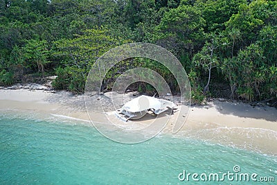 Aerial view part of destroyed boat on the beautiful tropical beach Stock Photo