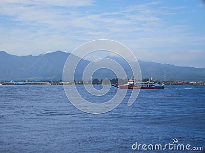 Aerial view passenger ferry floating in sea in background og mountains in Bali Editorial Stock Photo