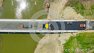 Aerial view on people with mechanization laying, spreading asphalt Stock Photo