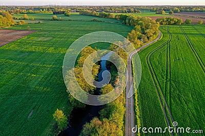 Aerial view of a picturesque rural farmstead with a river winding through the lush green landscape Stock Photo