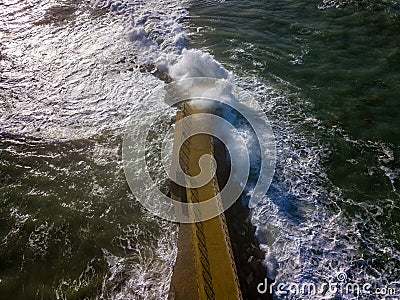 Aerial view of a pier with rocks. Pizzo Calabro pier, panoramic view from above. Broken pier, force of the sea. Power of Waves. N Stock Photo