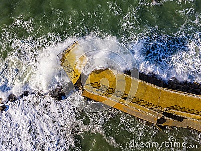 Aerial view of a pier with rocks. Pizzo Calabro pier, panoramic view from above. Broken pier, force of the sea. Power of Waves. N Stock Photo