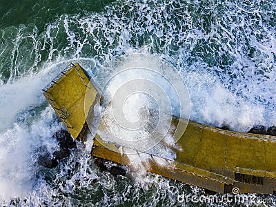 Aerial view of a pier with rocks. Pizzo Calabro pier, panoramic view from above. Broken pier, force of the sea. Power of Waves. N Stock Photo