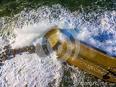 Aerial view of a pier with rocks. Pizzo Calabro pier, panoramic view from above. Broken pier, force of the sea. Power of Waves. N Stock Photo