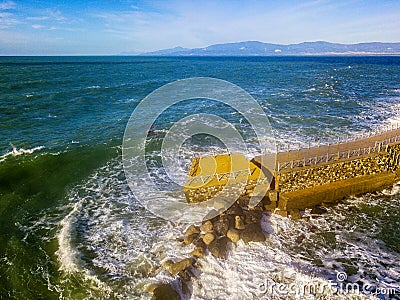 Aerial view of a pier with rocks. Pizzo Calabro pier, panoramic view from above. Broken pier, force of the sea. Power of Waves. N Stock Photo