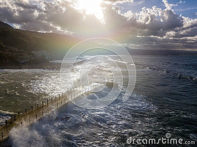 Aerial view of a pier with rocks. Pizzo Calabro pier, panoramic view from above. Broken pier, force of the sea. Power of Waves. N Stock Photo