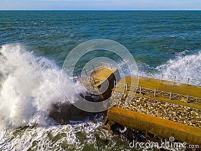 Aerial view of a pier with rocks. Pizzo Calabro pier, panoramic view from above. Broken pier, force of the sea. Power of Waves. N Stock Photo