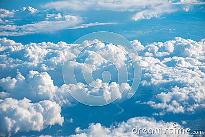 Aerial view from the plane over the clouds Stock Photo