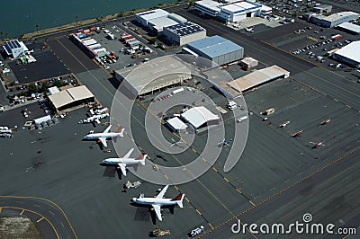 Aerial view of planes, helicopters, and cars parked by buildings Editorial Stock Photo