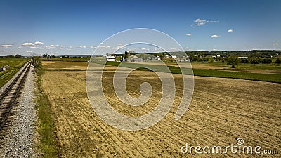 Aerial View of a Plowed Field with a Barn, Silos and Farm House in View Stock Photo