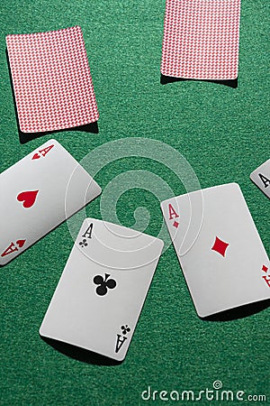 Aerial view of poker cards with aces, on green playing table Stock Photo