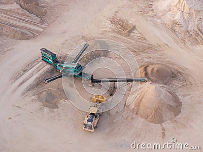 Aerial view of a quarry with conveyor belt and wheel loader - stones and sands for construction - top view , open pit mine, extrac Editorial Stock Photo