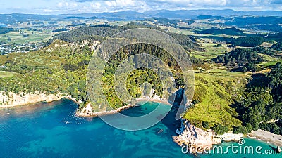 Aerial view on a remote ocean coast with small coves and mountains on the background. Coromandel, New Zealand. Stock Photo