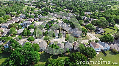 Aerial view residential neighborhood surrounded by matured trees and grassland in Flower Mound, Texas, US Stock Photo