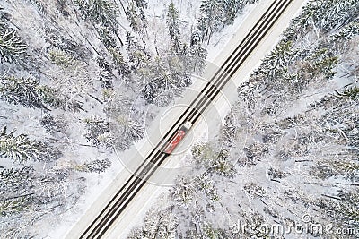 Aerial view of road with red truck in winter forest Stock Photo