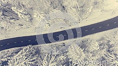 Aerial view of road through a winter forest. Stock Photo