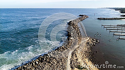 Aerial view of rock sea wall boat harbour with stand up paddle boarders near piers Stock Photo