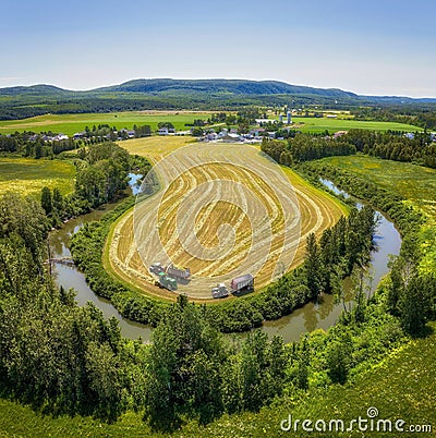 Aerial view of a rural farmstead surrounded by cultivated agricultural fields in St-Donat, Quebec. Stock Photo